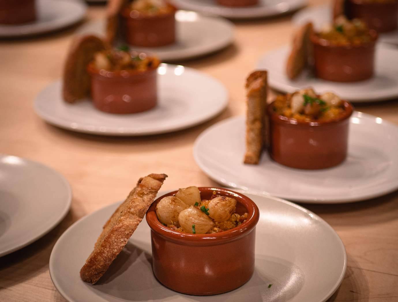 Corn flan, chorizo brunoise, burnt onions, bread croutons with olive oil, chives
