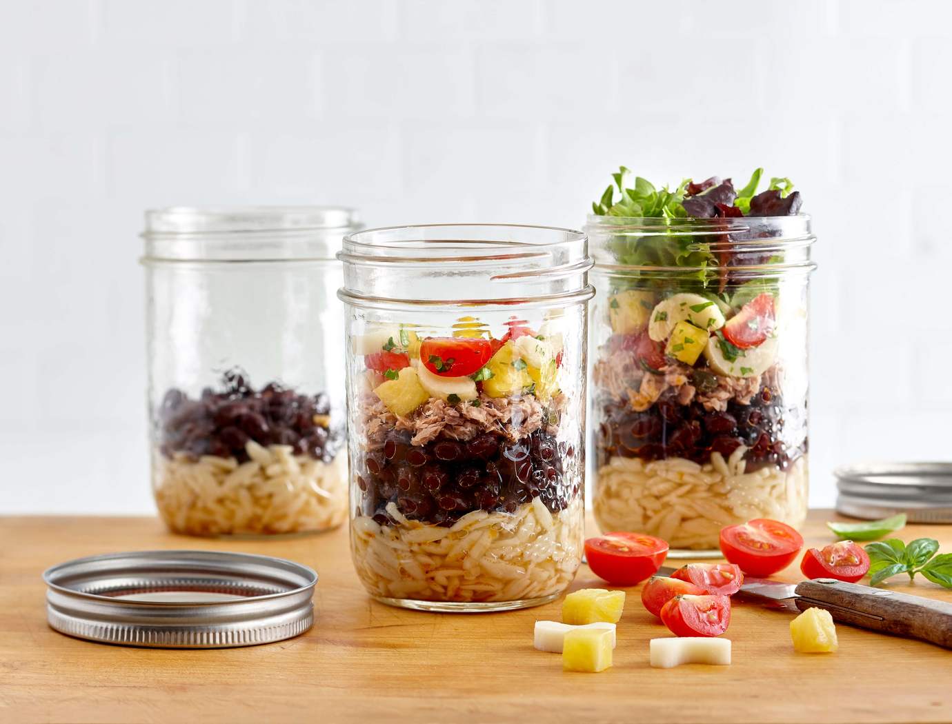 Orzo salad with black beans, tuna, capers, tomatoes and basil marinated legumes